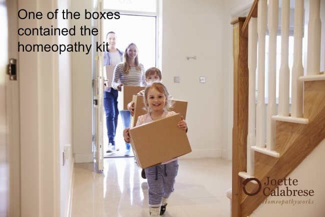 Family Carrying Boxes Into New Home On Moving Day